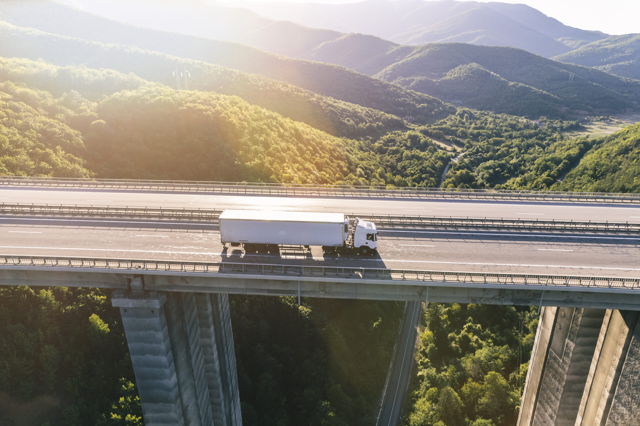 <a href="https://www.freepik.com/free-photo/trucks-highway-mountain-sunset_31177932.htm#query=truck%20transport&position=1&from_view=search&track=ais&uuid=498dce54-687d-4819-a833-5eb525758f6d">Image by wirestock</a> on Freepik
