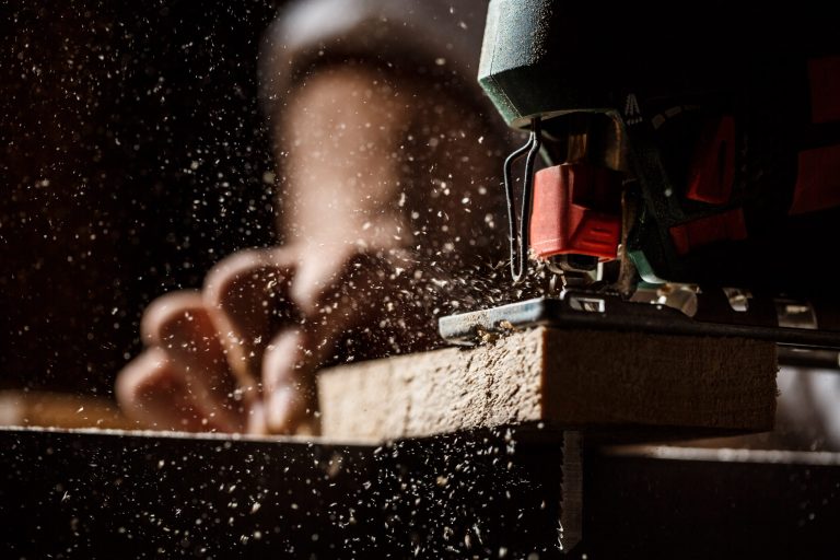 Close up photo of cutting wood with fretsaw