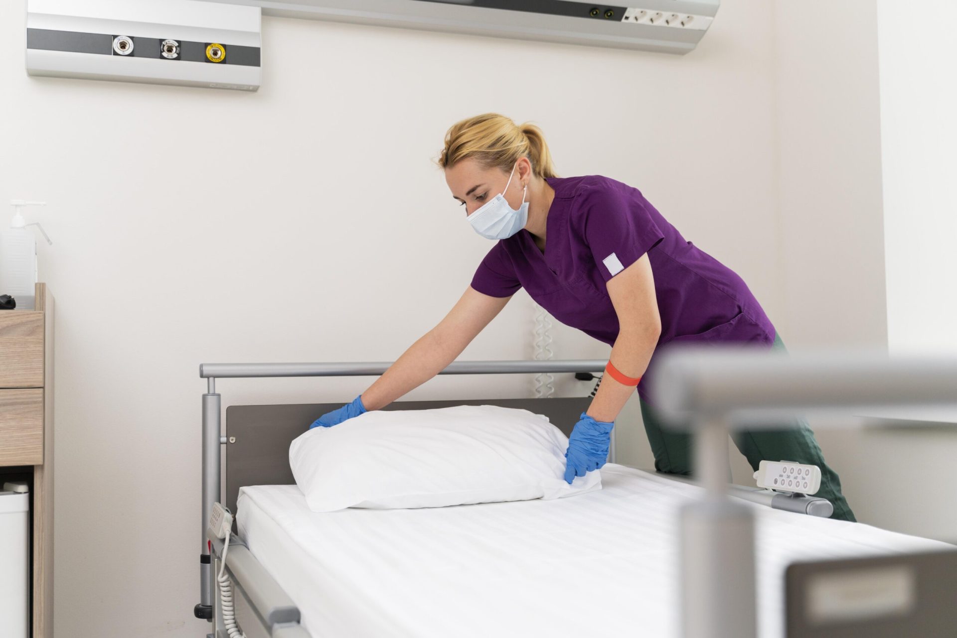 Image by <a href="https://www.freepik.com/free-photo/female-student-medicine-wearing-medical-mask-while-doing-her-practice_16408907.htm#query=making%20hospital%20bed&position=1&from_view=search&track=ais&uuid=46a5e158-2592-489f-994e-cc118b4ce1a7">Freepik</a>